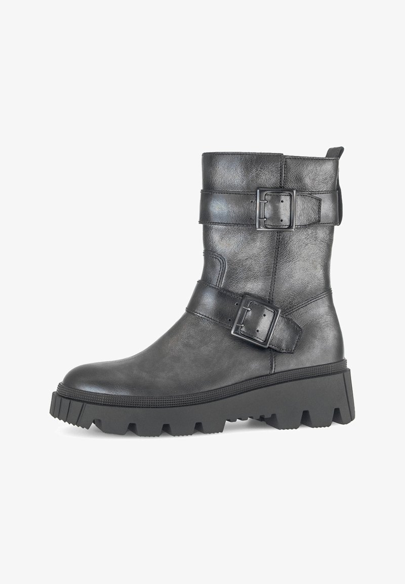 Black leather ankle boot with two prominent buckles, textured surface, chunky rubber sole, and a slightly rounded toe.