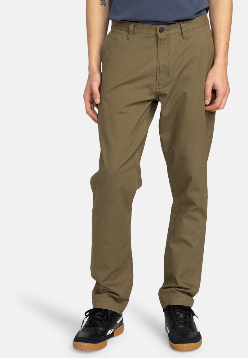Khaki cargo pants made of cotton blend, featuring a straight leg design, front pockets, and a button closure. Paired with black sneakers.