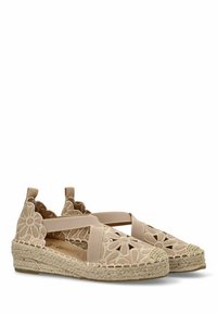 Zapatos de esparto beige con recortes florales, correas elásticas y suela envuelta en yute. La tela texturizada y los acentos tejidos realzan el diseño.