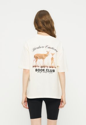 Person with long brown hair wearing a white T-shirt showing two deer and text "Hardcore Emotional Book Club every Friday 6-8pm" on the back.