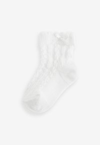 Calzino bianco di cotone con polsino a coste, dotato di un accento a fiocco e un design a treccia testurizzata lungo il lato. Finitura liscia complessiva.