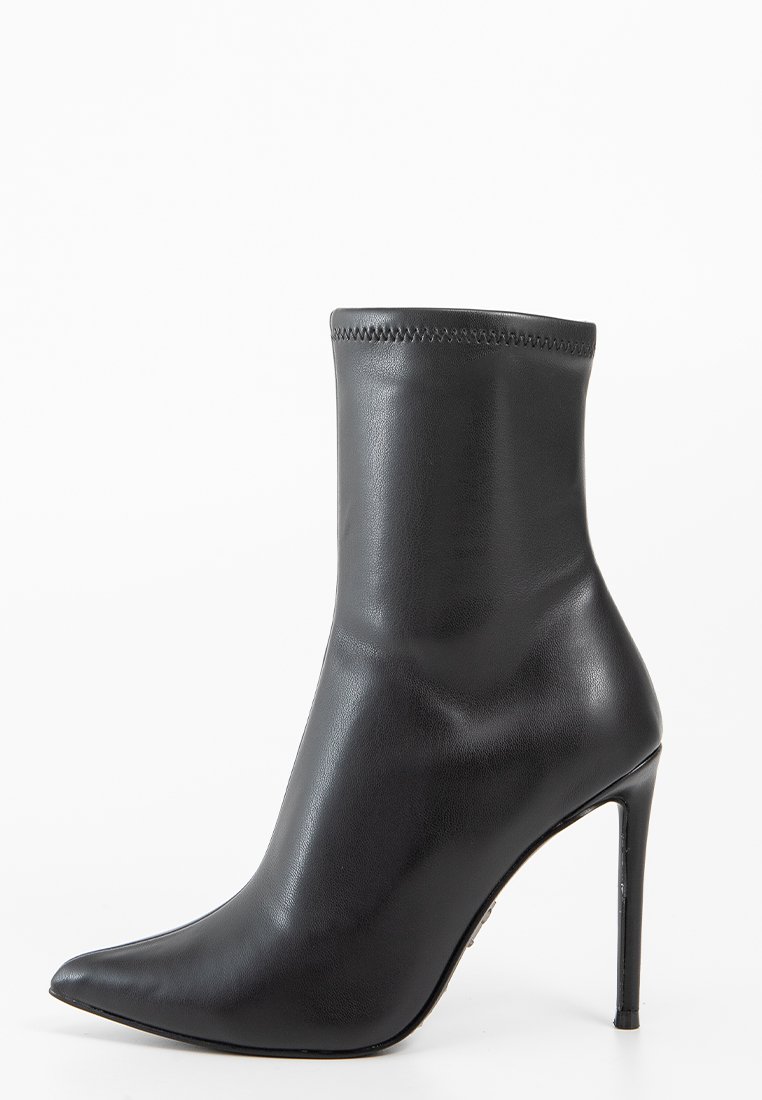 Czarny skórzany botek za kostkę z wydłużonym noskiem i wysokim obcasem w kształcie stiletto, gładkie wykończenie i przeszywany górny brzeg.