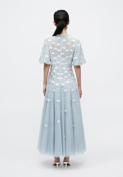 Ljusblå klänning med genomskinligt tyg, blomsterbroderier, puffärmar, lång kjol och dragkedja baktill.