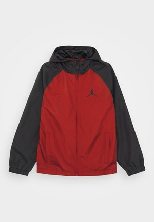 Rot-schwarze Sportjacke mit Kapuze, durchgehendem Reißverschluss vorne und elastischen Bündchen, mit schwarzem Jumpman-Logo auf der Brust.
