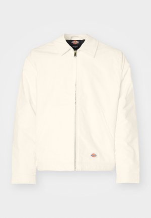 White zip-up jacket with a pointed collar, smooth texture, side pockets, and a small logo patch on the left hip.