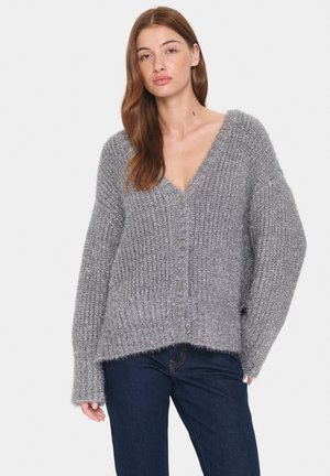 Comfortable gray knit cardigan with a v-neck, oversized sleeves, and button closure. Soft texture with a slightly fuzzy finish.