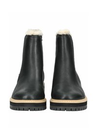 Botas de tobillo de cuero negro con un cuello de borreguillo, forma esbelta y suela de goma texturizada. Presenta un borde beige en la base.