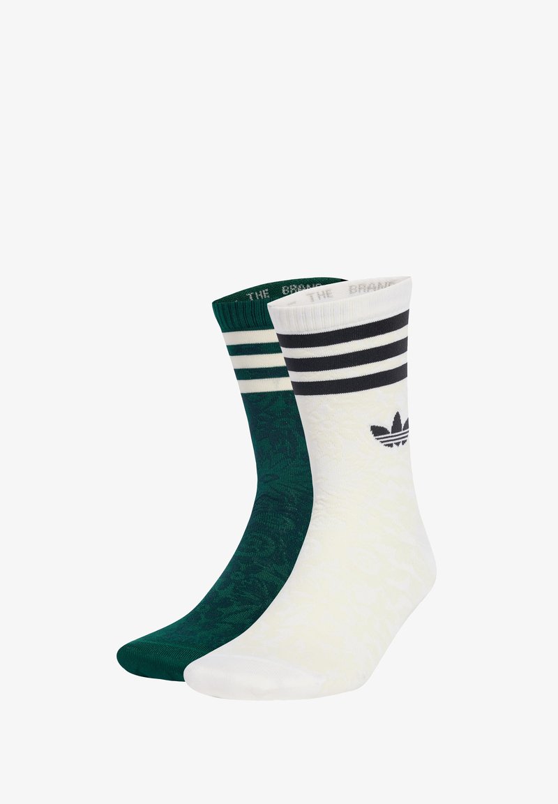 Two pairs of socks; one green with a textured pattern and a ribbed cuff, the other white with black stripes and a logo, smooth texture.