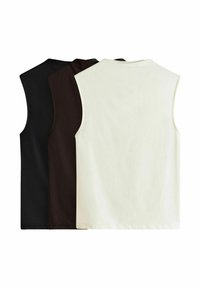 Three sleeveless tops in black, dark brown, and cream. Made of smooth, soft fabric with a simple design and rounded necklines.