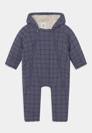 Granatowy body dla niemowląt w kratę, z podszytym kapturem, dwoma frontowymi zamkami błyskawicznymi i długimi rękawami. Miękka tekstura tkaniny.
