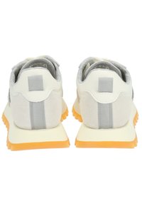 Footwear featuring a light gray suede and white synthetic upper, with a textured gray lining and a prominent orange rubber sole.