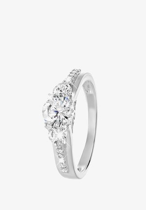 Diamond ring with a central round stone, flanked by smaller diamonds. Silver band, featuring a textured surface and multiple sparkling accents.