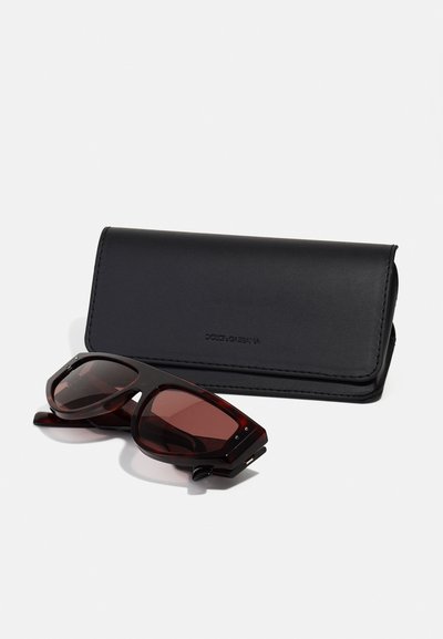 Brown tortoiseshell sunglasses with dark lenses, accompanied by a sleek black leather case featuring embossed branding and a fold-over design.