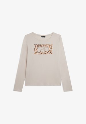 Chemise beige à manches longues en coton doux, ornée d'un imprimé zèbre rayé métallique doré et noir, avec un logo rectangulaire au centre.