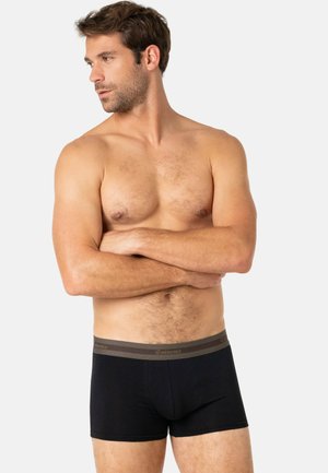 Boxer-briefs noirs avec une taille douce couleur marron arborant le logo "Eminence". Matière lisse, design ajusté et longueur au milieu de la cuisse.