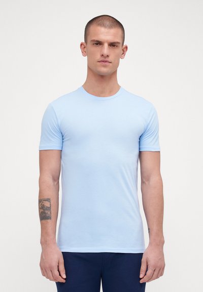 Light blue, short-sleeve t-shirt with a round neckline, made of soft fabric, featuring a fitted design. Textured fabric details visible.