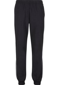 Sorte joggebukser med elastisk liv, smale ankler og hvite striper på sidene. Laget av myk stoff, med en jevn tekstur.