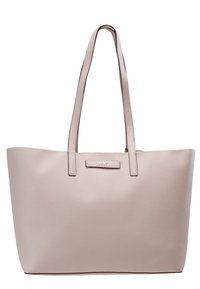 Sac fourre-tout en cuir beige avec de longues poignées doubles et une petite plaque logo à l'avant, forme rectangulaire avec une ouverture supérieure légèrement plus large.
