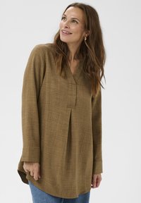 Túnica marrón de manga larga con cuello en V y detalle de pliegues, confeccionada en tela texturizada, con dobladillo curvado y puños sencillos.