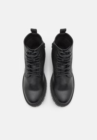 Black leather ankle boots with a round toe. Features include lace-up front, zipper on the side, and textured upper with a smooth finish.