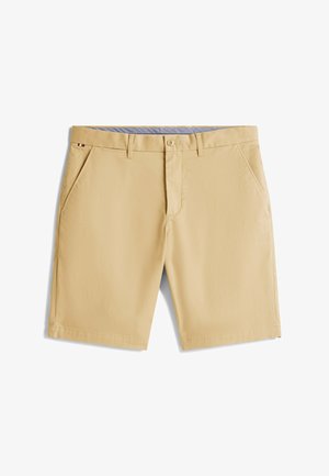 Beżowe szorty z lekkiego materiału, z dwoma bocznymi kieszeniami, zapięciem na guzik oraz niebieską, wzorzystą talią.