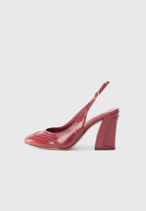 Red patent leather slingback heel, featuring decorative perforations, a rounded toe, and a chunky heel for stability.