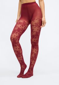 Burgunderfarbene Strumpfhosen mit floralem Spitzenmuster, durchsichtig von der Taille bis zu den Zehen, mit einem hohen Bund für Unterstützung. Glatte Textur und figurbetontes Design.