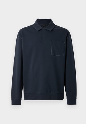 Navy blue long-sleeve polo shirt made of soft fabric, featuring a buttonless placket and a patch pocket with contrasting stitching detail.