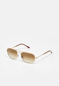 Gold aviator sunglasses with gradient brown lenses, metal frame, and brown plastic temple tips. Smooth texture, minimal hardware detail.