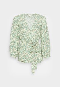Blusa envolvente floral em verde claro com detalhes em branco e dourado, apresentando mangas bufantes longas e uma cintura com laço. Feita de tecido leve.