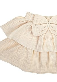 Warstwowa spódnica z miękkiej beżowej tkaniny o fakturze. Posiada szeroki pas w talii oraz dużą kokardę z przodu. Lekka i falbaniasta konstrukcja.