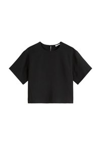 Top nero corto con maniche corte, scollatura rotonda e chiusura con zip sul retro. Il tessuto appare liscio con un design minimalista.