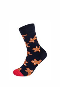 Námořnické ponožky s potiskem perníkových mužíků, s červenými akcenty na patě a špičce. Vyrobené z měkkého, pružného materiálu pro pohodlí.
