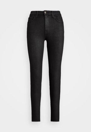 Black high-waist skinny jeans featuring front button, zipper fly, belt loops, and five-pocket design against a white background.