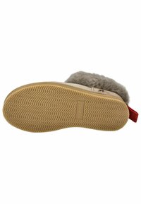 Tan slipper with a textured rubber sole, grey fur lining, and a red fabric pull tab. Features a zigzag pattern on the sole.