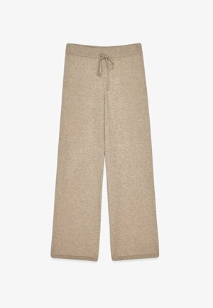 Beige leveled trousers valmistettu pehmeästä kankaasta, jossa on elastinen vyötärönauha ja nauha, sekä ribbikuvioidut helmalaadut.