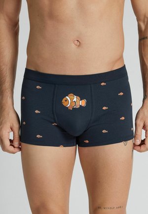 Mand iført mørke boxer shorts med mønster af mange små klovnefisk og en større klovnfisk placeret midt foran.