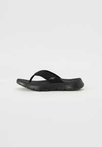 Black flip-flop sandal with a textured synthetic upper, cushioned sole, and thin straps for secure fit. Lightweight design.