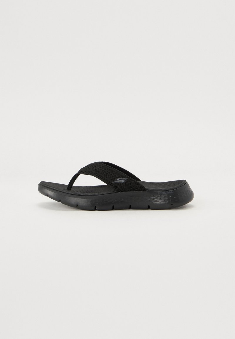 Black flip-flop sandal with a textured synthetic upper, cushioned sole, and thin straps for secure fit. Lightweight design.