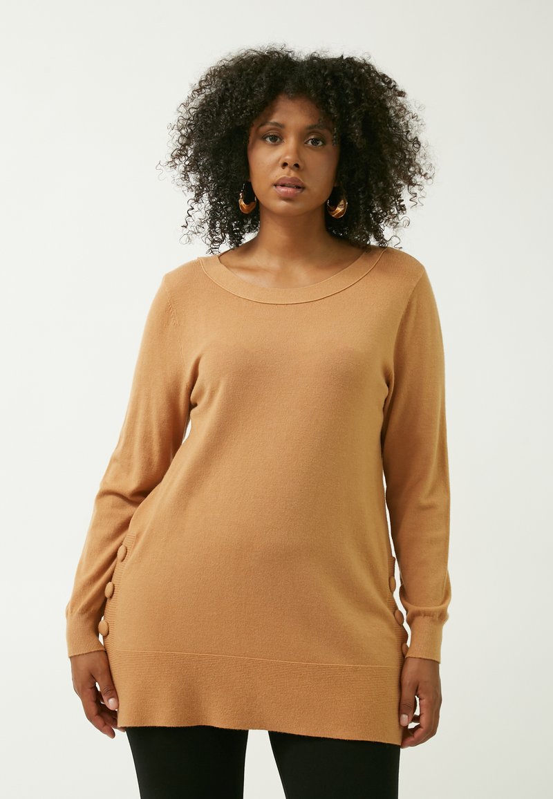 Karamelbrun strikket sweater med rund halsudskæring og lange ærmer. Har dekorative knapper langs siden og en ribbet kant. Blød tekstur.