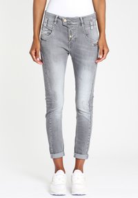 Grijze denim skinny jeans met een versleten textuur, voorzien van een knoop- en ritsluiting, zijzakken en opgerolde manchetten.