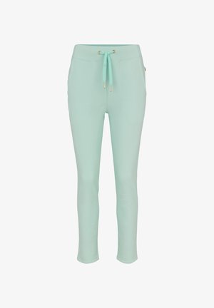 Hellgrüne Jogginghosen aus weichem Stoff, mit einem Tunnelzug in der Taille mit goldenen Akzenten und einem enganliegenden, zulaufenden Bein.