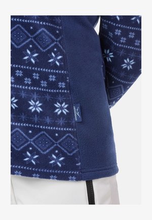 Maglione in pile di colore blu navy con motivi di fiocchi di neve e geometrici in azzurro chiaro. Dotato di etichetta laterale e texture morbida. Dettagli con zip visibili.