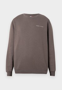 Sweat-shirt marron col rond avec manches longues, poignets et bas côtelés, et petit logo blanc "Tommy Jeans" sur la poitrine gauche.