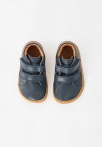 Dark blue leather shoes with dual Velcro straps and a tan rubber sole. Interior features a padded tan lining for comfort.