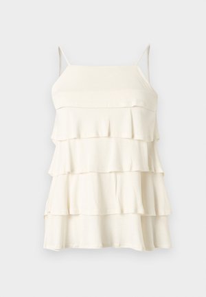 Λευκό αμάνικο φόρεμα με στρώσεις, λεπτές τιράντες στους ώμους και ίσια λαιμόκοψη σε απλό φόντο.