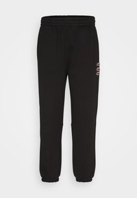Svarta sweatpants i mjukt bomullsmaterial, med elastisk midja och muddar, och en liten broderad logotyp på sidan.