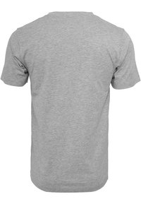Camiseta corta de manga gris claro, vista desde la parte posterior sobre un fondo blanco.