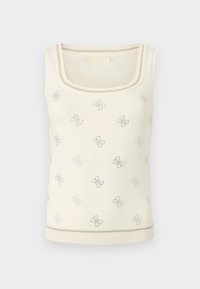 Haut en maille crème sans manches avec encolure carrée et petits logos brodés argentés dispersés sur le tissu.
