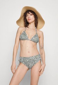 Bikini set with green and white abstract print, triangle top with halter straps, and adjustable side-tie bottoms; straw sun hat.